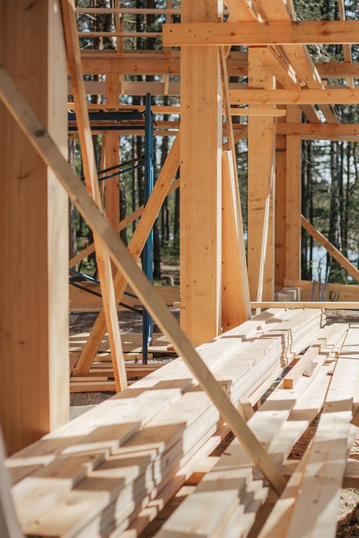Services-03 Sunlit construction site with wooden lumber arranged in rows. Perfect for building projects.
